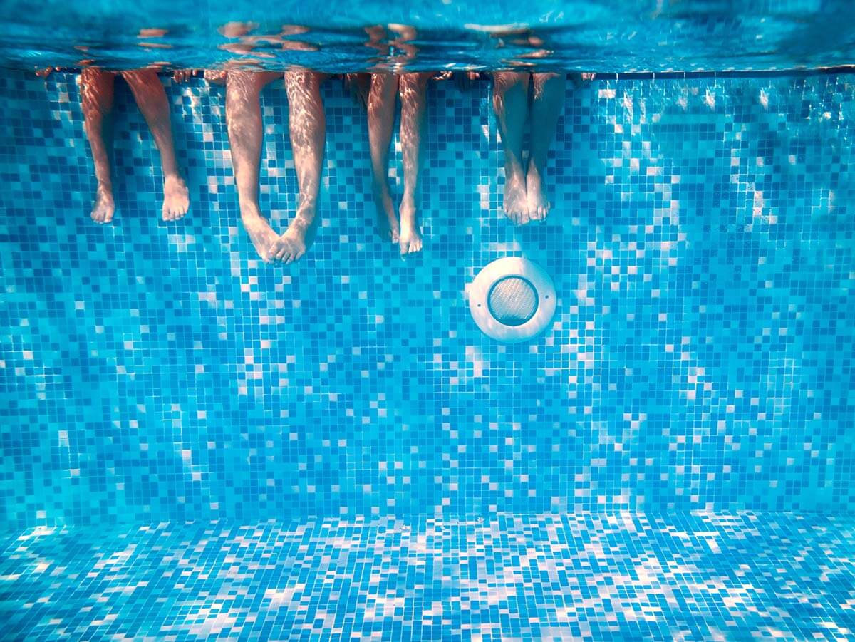 Children's and adults legs underwater