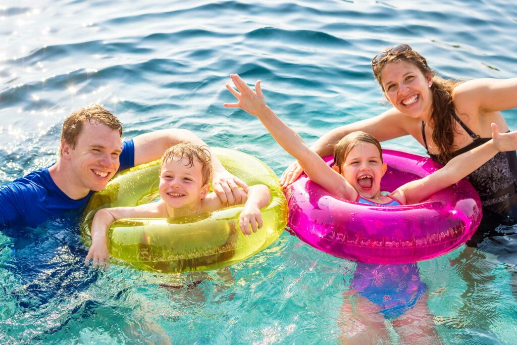 family playing together in the water