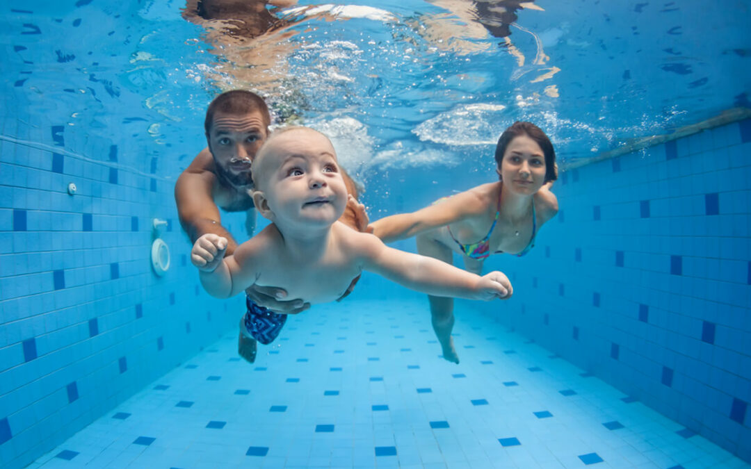 family swimming at the pool