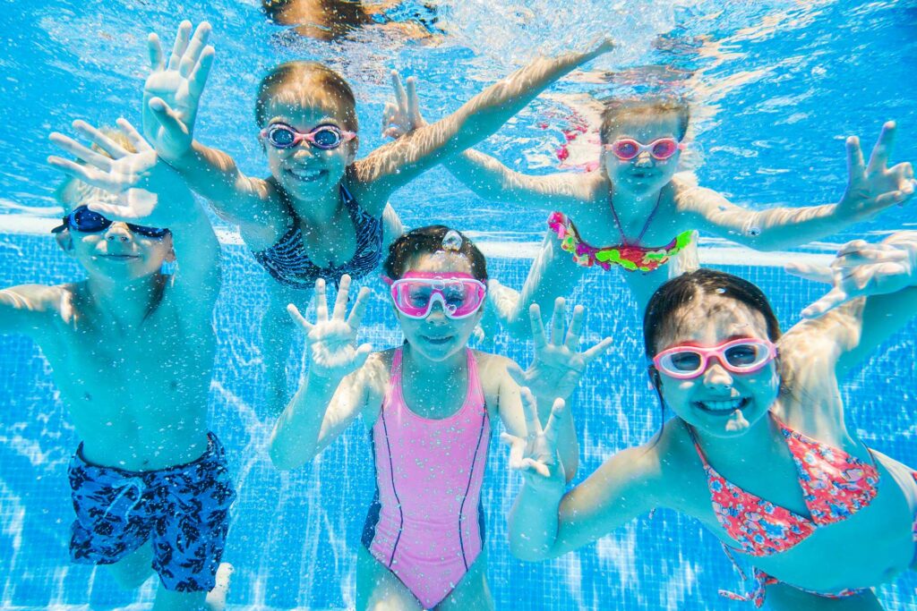 kids playing in a pool as a group