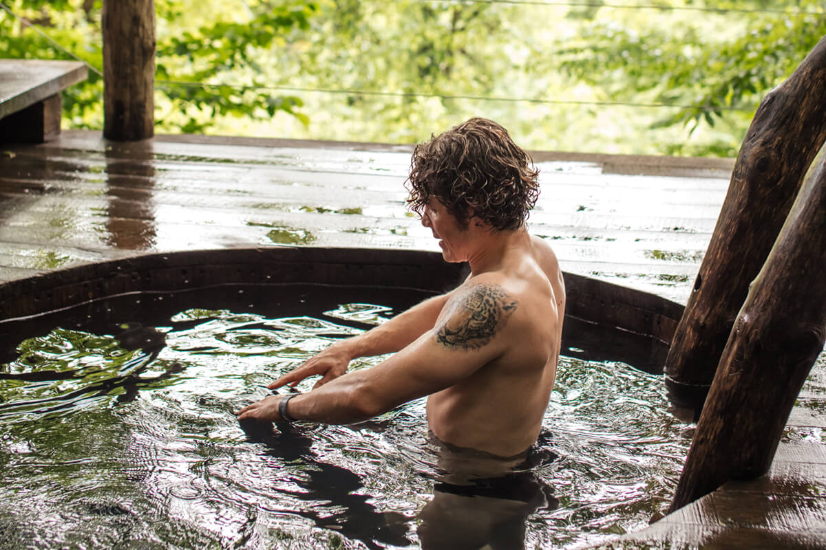 sporty man is doing exercise in water while bathing